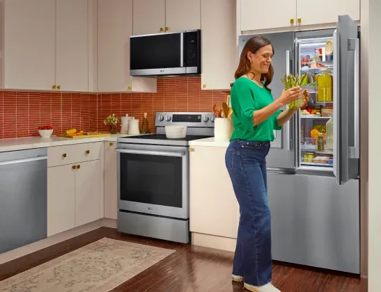 lg-french-door-refrigerator-woman-open-fridge